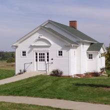 Photo of a white schoolhouse