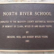 Donation plaque on the side of the building
