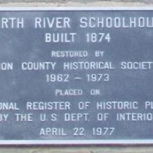 Plaque on the side of the building