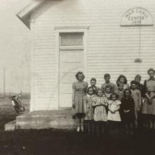 A class standing outside the school