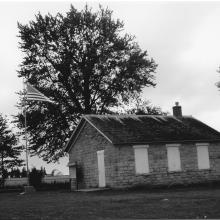 Black and white photo of a stone schoolhouse
